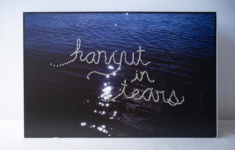 Nadirah's artwork 'hanyut in tears' (pearl-pinned text on lightbox, 2025). Photo: The Back Room