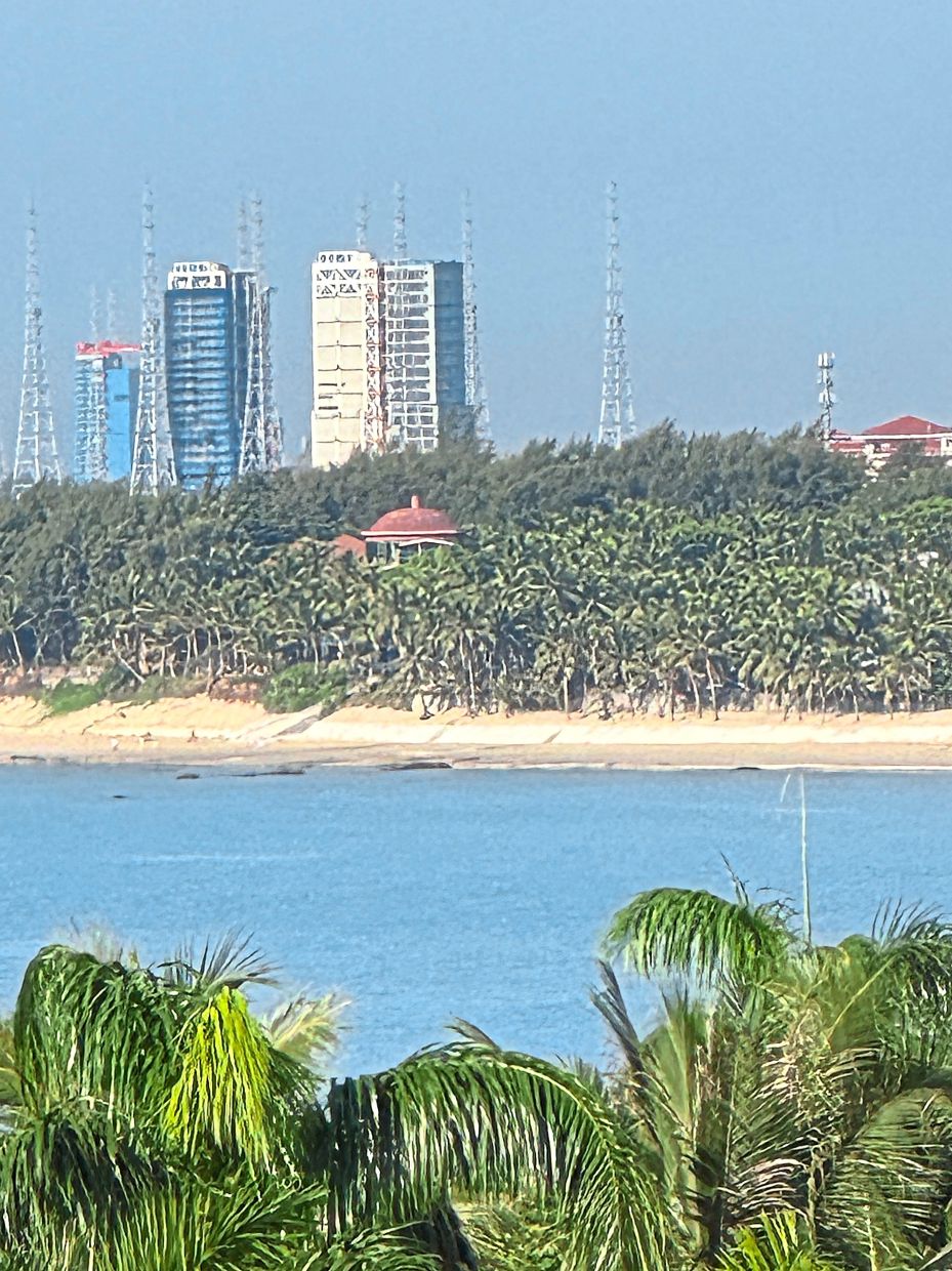 White beaches, palm trees and the rocket launch pad. A perfect view from the balcony of Wenchang Hilton in Hainan, China.