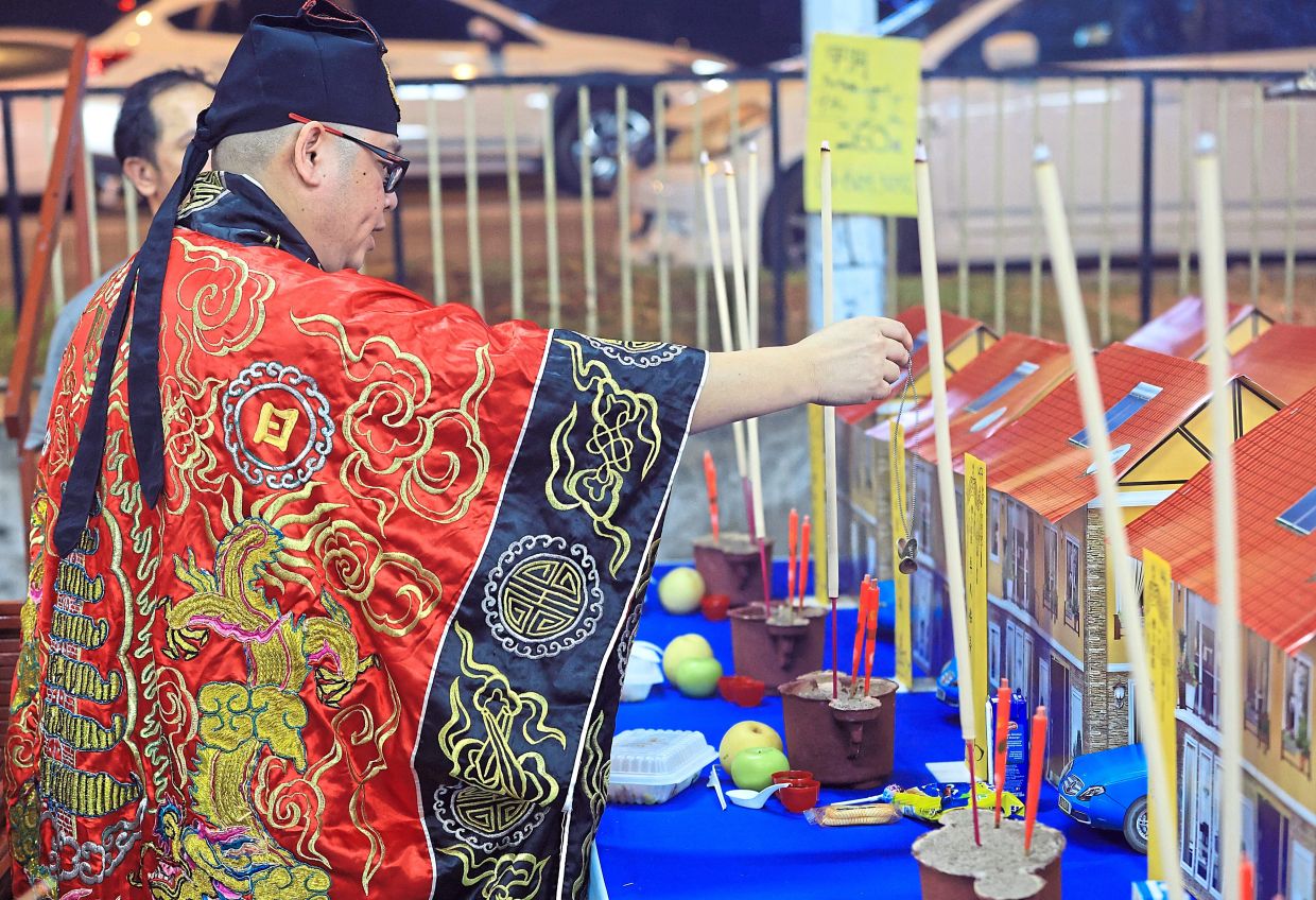 A priest conducting a ritual during the Hungry Ghost Festival.