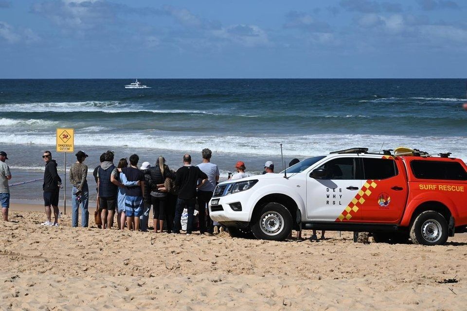 Family and friends of a man who died after a shark attack gathering at Long Reef Beach in Sydney on Sept 6, 2025. - Photo: EPA