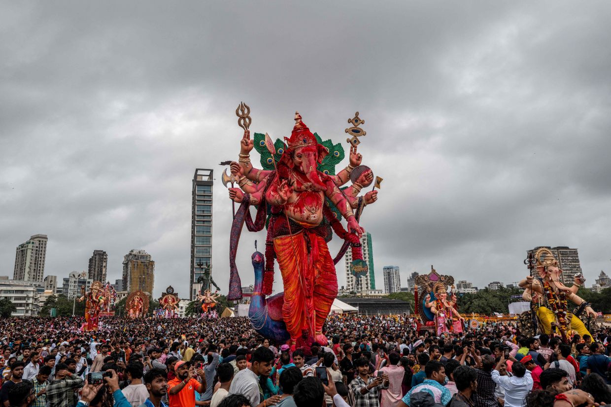 Devotees carry idols of the elephant-headed Hindu deity Ganesha for their immersion in the Arabian Sea in Mumbai on Saturday, September 6, 2025, on the last day of the Ganesh Chaturthi festival. -- Photo by Punit PARANJPE / AFP