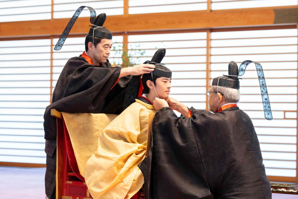 This handout photo taken on Saturday, September 6, 2025, by the Imperial Household Agency of Japan shows Japan's Prince Hisahito (centre) attending his coming-of-age ceremony, Kakan-no-Gi, at the Imperial Palace in Tokyo. - Photo from AFP