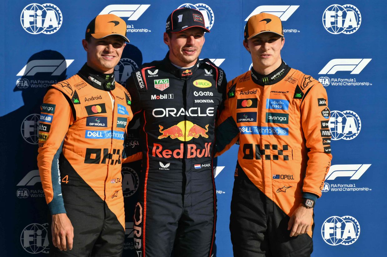 Red Bull Racing's Dutch driver Max Verstappen (centre) celebrates his pole position with second-placed McLaren's British driver Lando Norris (left) and third-placed McLaren's Australian driver Oscar Piastri after the qualifying session ahead of the Italian Formula One Grand Prix at the Autodromo Nazionale Monza circuit, in Monza, northern Italy, on Saturday, September 6, 2025. -- Photo by Marco BERTORELLO / AFP