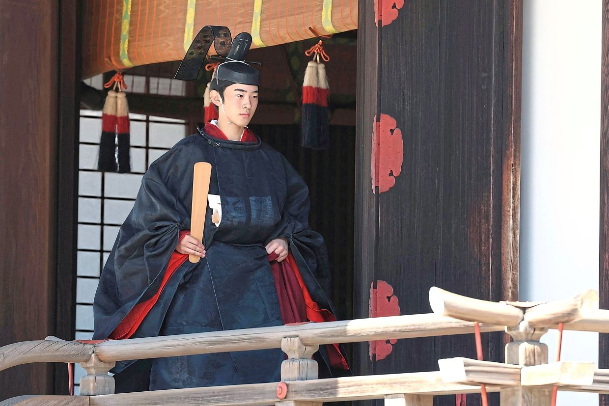 The prince wearing an ancient ceremonial costume. — AFP/AP
