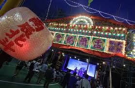 People take part in ceremonial rituals for the Hungry Ghost Festival at Carpenter Road Park, Kowloon City, Hong Kong. -- Photo: Edmond So/SCMP