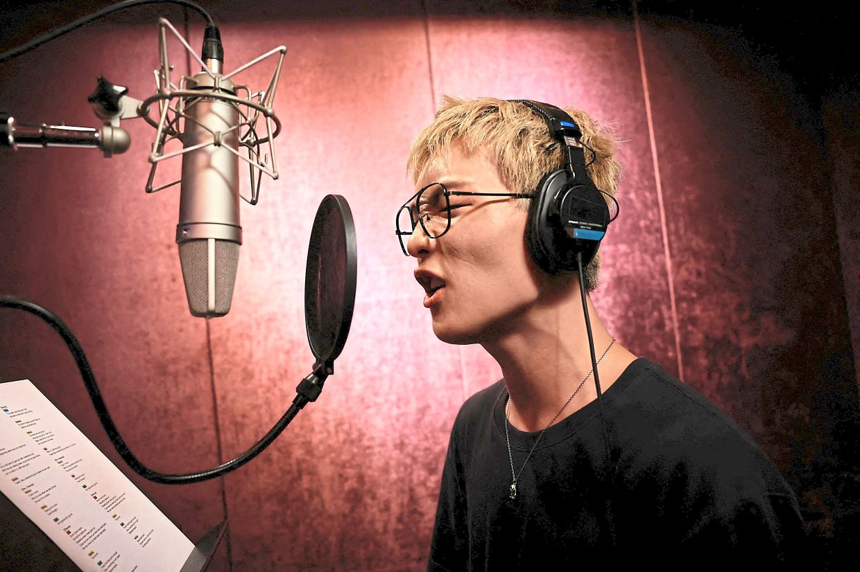 Well-rounded: Hyuk recording vocals for a new track at a studio in Seoul. — Reuters