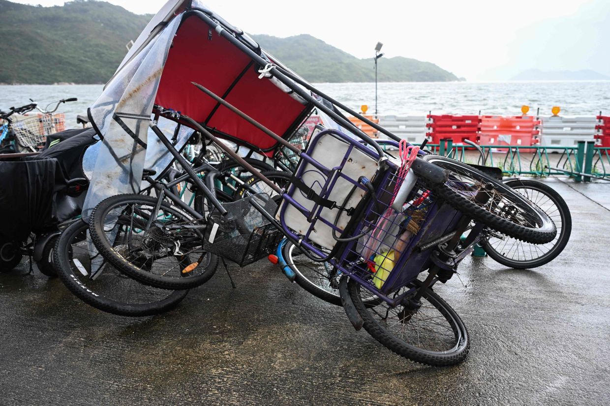Bicycles are seen blown over as Typhoon Tapah heads to the coast near Hong Kong on Sept 8, 2025. - AFP