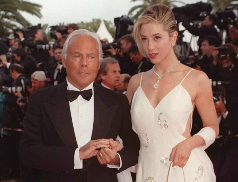 Giorgio Armani arrives with actress Mira Sorvino at the Festival Palace in Cannes on May 11, 1997, to attend the 50th birthday celebration of the Cannes International Film Festival. Photo: AP