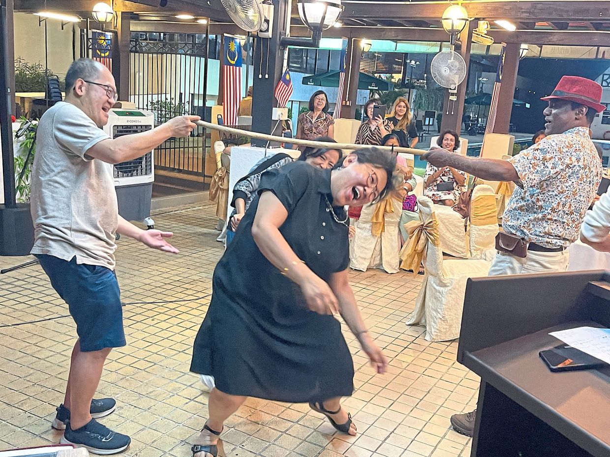 Alumni and other attendees adding a playful touch to the evening with a round of limbo.