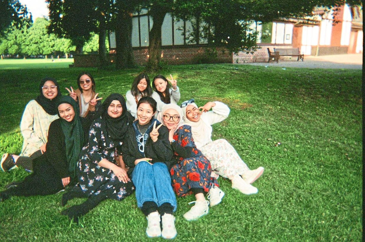 Ang (back row, second from right) says being with her friends gives her a sense of belonging. Photo: ANG WEI WEN