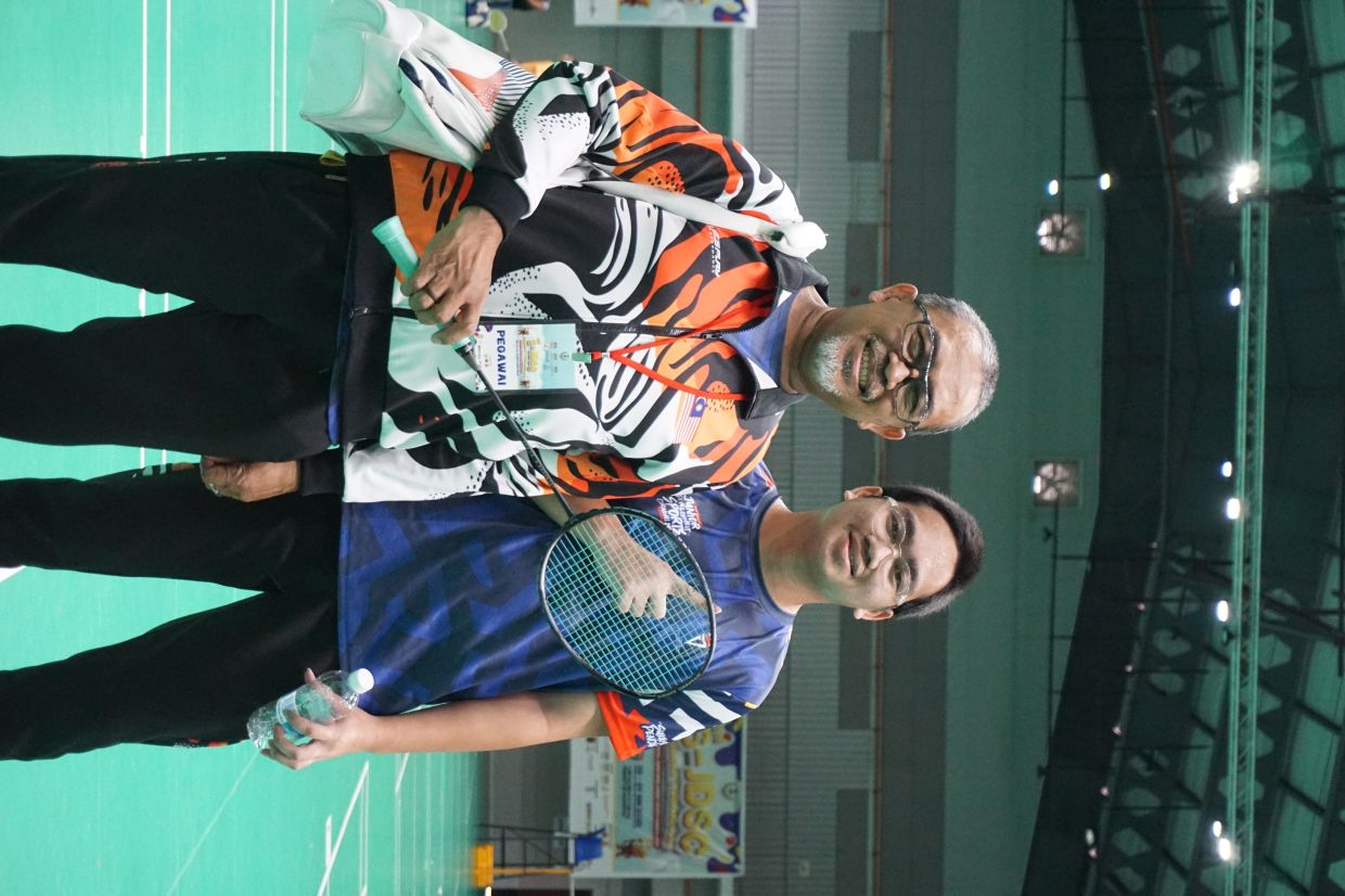 Mat Noor (left) has been a pillar of support throughout his son Muhammad Hafiyyan’s badminton journey.