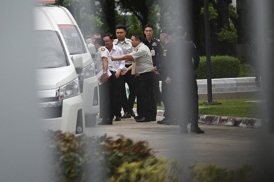 Former Thai Prime Minister Thaksin Shinawatra is escorted by corrections officers after the supreme court ruled to return Thaksin to prison for one year, in the case of his unlawful six-month hospital stay before he was granted parole, in Bangkok, Thailand, September 9, 2025. - Photo: Reuters