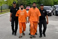 Two Pakistani men charged with smuggling nine countrymen into Malaysia