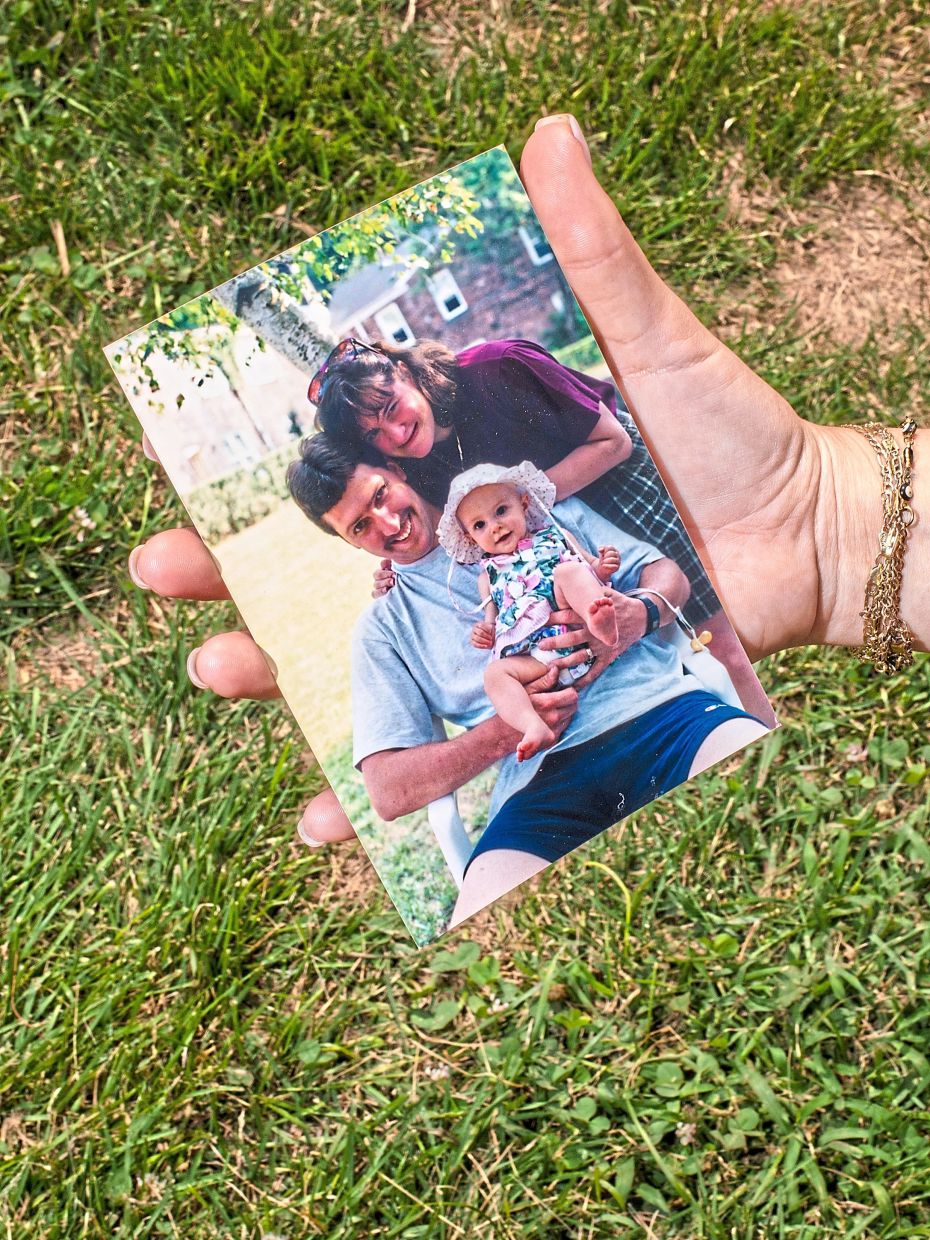 Miller holding a photograph of her as a child with her father. — Bryan Anselm for The New York Times
