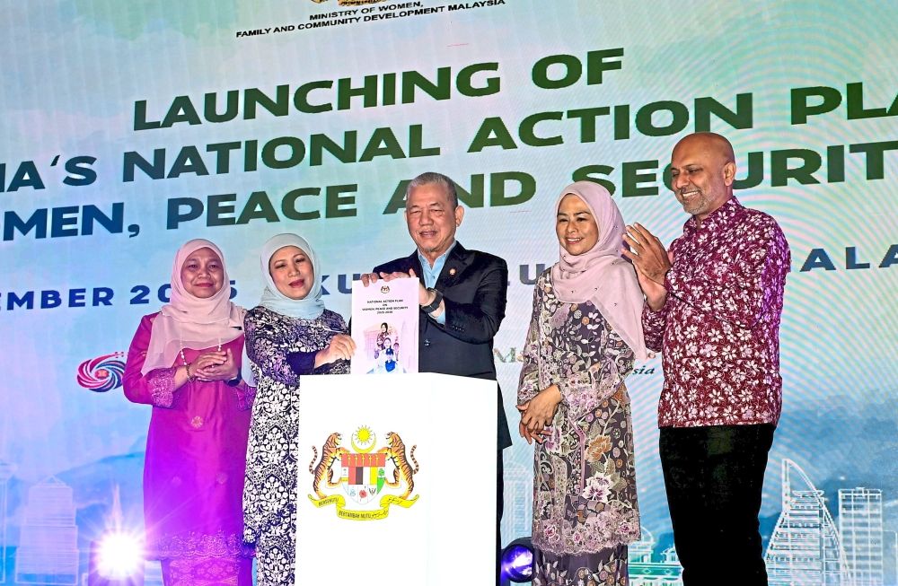 Championing women’s role: Fadillah (centre) and Nancy (second from left) at the launching of Malaysia’s National Action Plan on Women, Peace and Security, which took place in Kuala Lumpur.