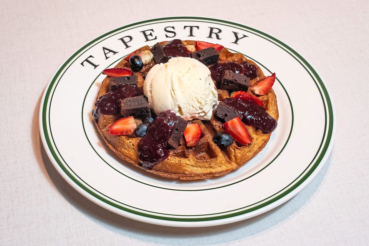 Berries and vanilla ice-cream are loaded on a house-made waffle for a sweet, sweet delight. — Tapestry
