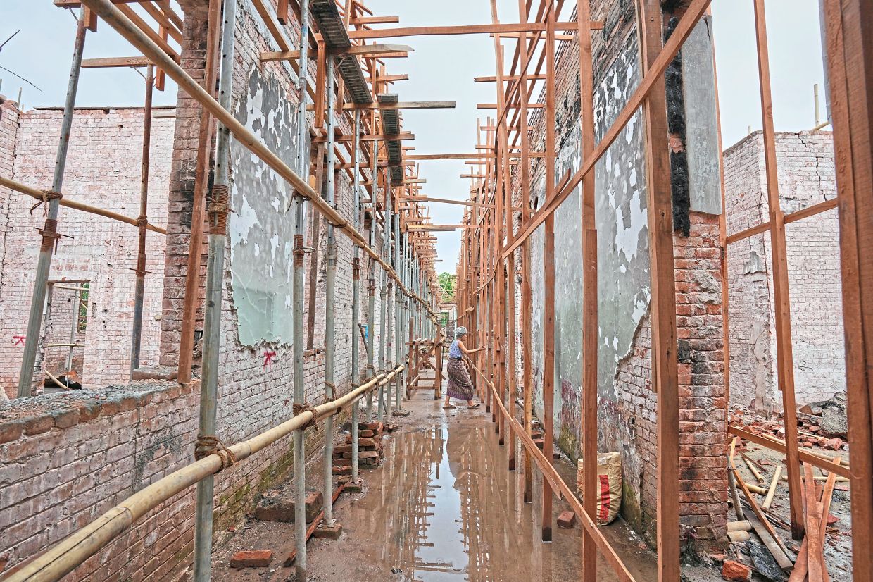 Labourers work at a building in the Mandalay University compound that was damaged in the March 28 earthquake in Mandalay. — AP