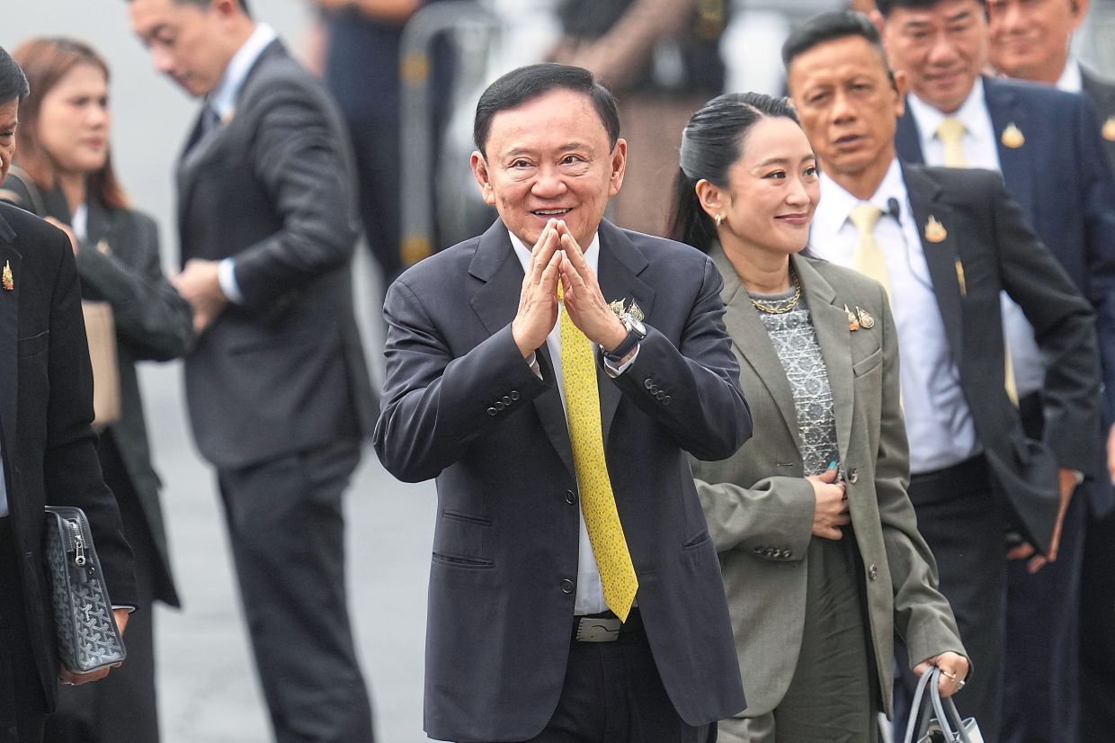 Thaksin’s adviser role on hold pending talks