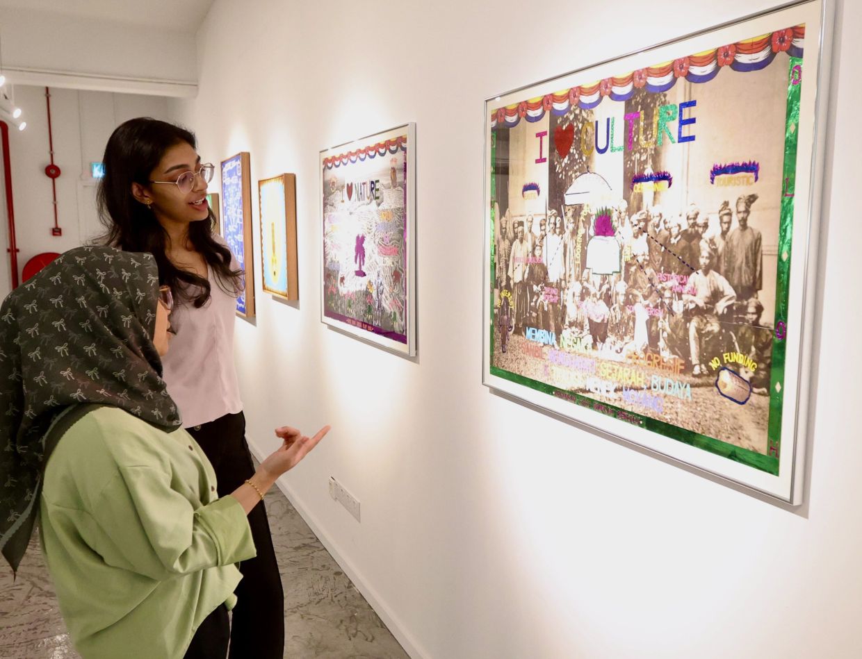 Visitors view Anas Afandi’s new series at the 'Reframe & Resist: Decolonise Here and Now!' exhibition at Harta Space. Photo: Low Boon Tat/The Star 