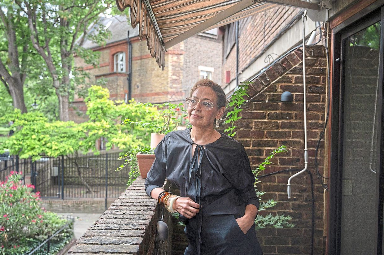 Faceystanding under the awning which she installed to cool her London home. — Mary Turner/The New York Times