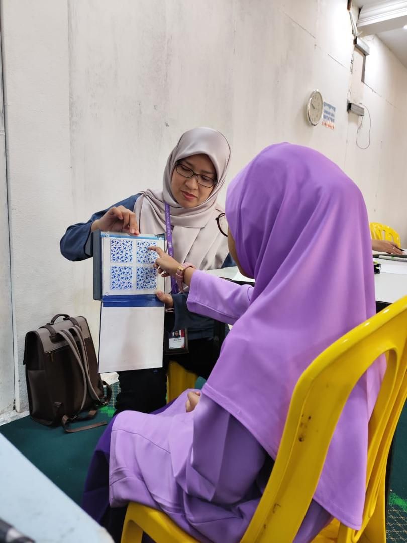 Ophthalmologist Dr Farhana Mustafa examines a student's 3D vision using a Frisby test.