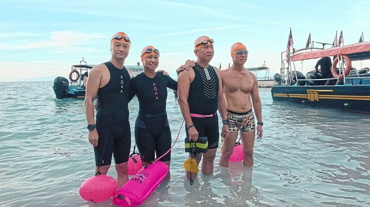 (from left) Chang, Wong, Dr Chooi and Thong just before they start their 10km swim from Pulau Lang Tengah to Pulau Redang.