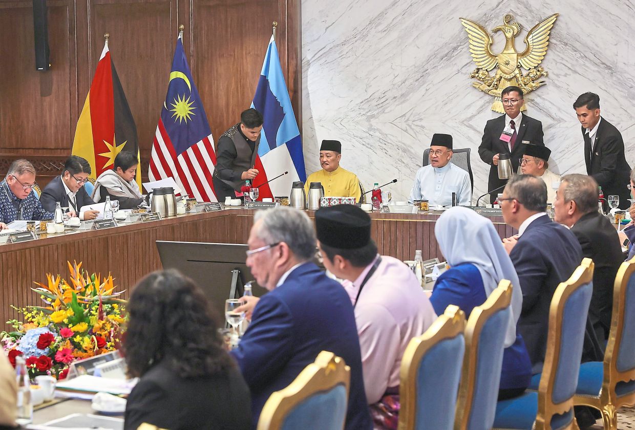 Healthy partnership: Anwar, flanked by Hajiji and Abang Johari, chairing the MA63 implementation action council meeting number 1 of 2025 at the Satria Pertiwi Complex in Kuching. — Bernama
