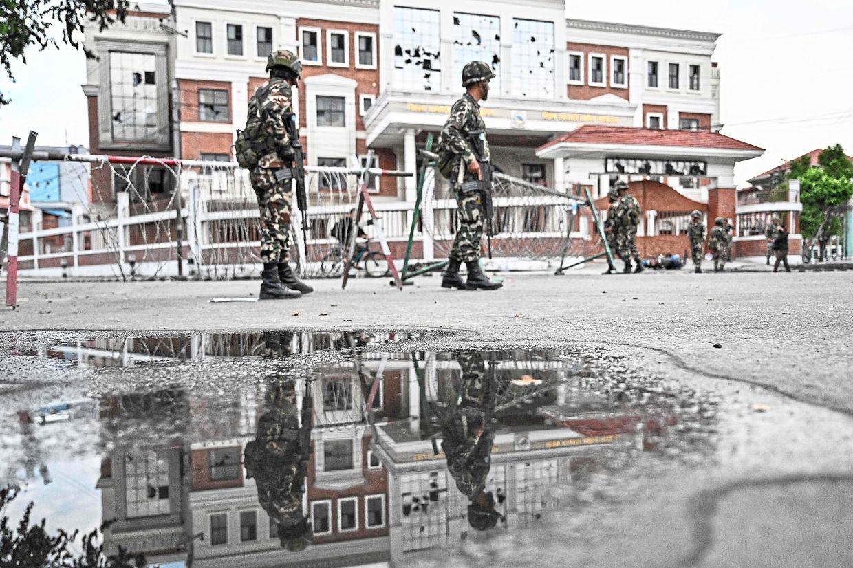 Quiet streets: Army personnel keeping watch during a curfew imposed to restore law and order in Kathmandu. — AFP