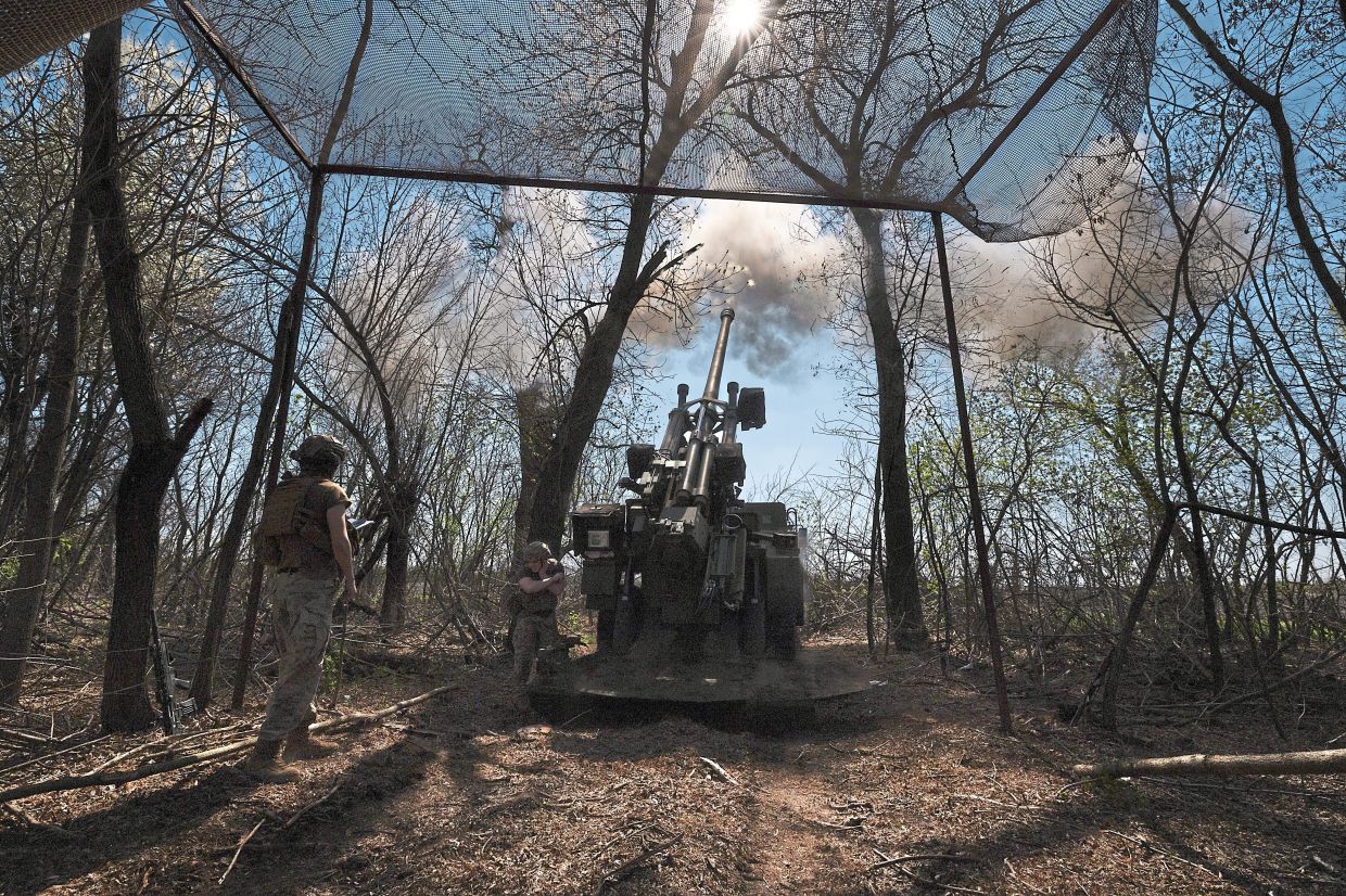 Ukrainian soldiers fire a French Caesar self-propelled howitzer at a Russian target in the Donetsk region of eastern Ukraine in April. — Tyler Hicks/The New York Times