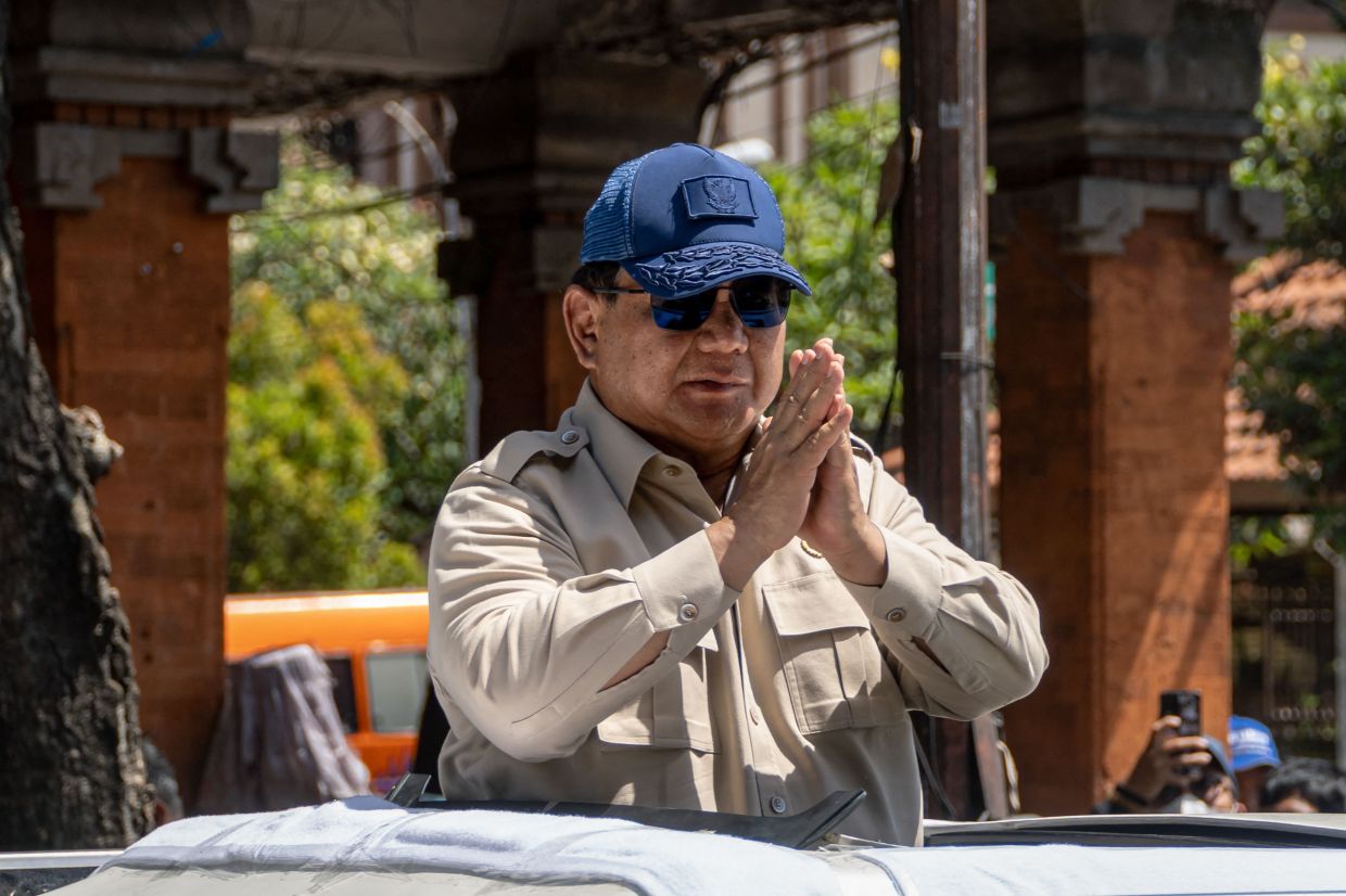 Indonesia's President Prabowo Subianto greets residents during a visit to a flood-affected area in Denpasar on Indonesia's resort island of Bali. The death toll from the flooding that struck two Indonesian islands, including tourist hotspot Bali, rose to 23 on September 12, officials said, with five other people still missing. -- Photo by Dicky Bisinglasi / AFP