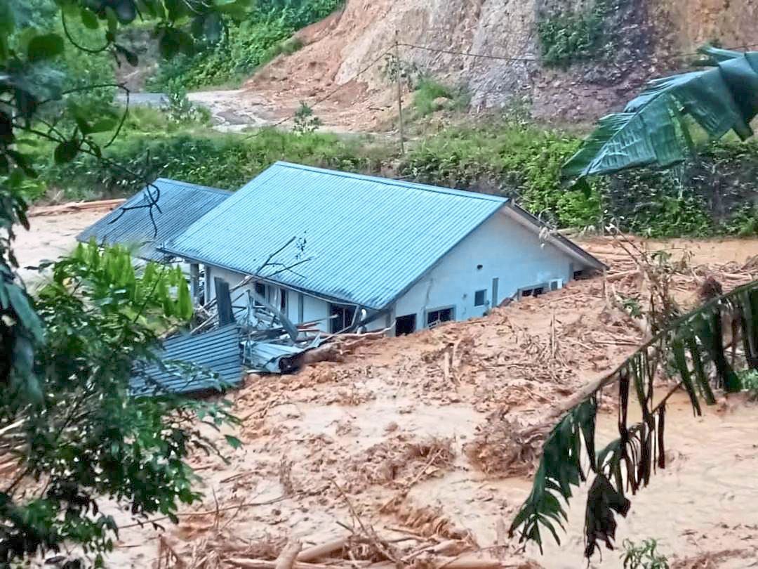 The house submerged in mud.