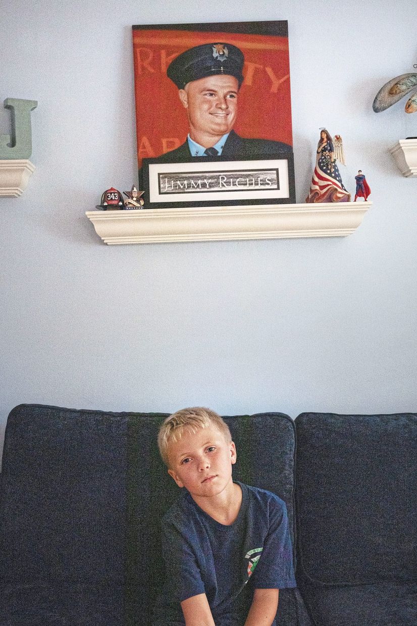 Tommy sitting under a portrait of his uncle Jimmy at his house. — Natalie Keyssar/The New York Times