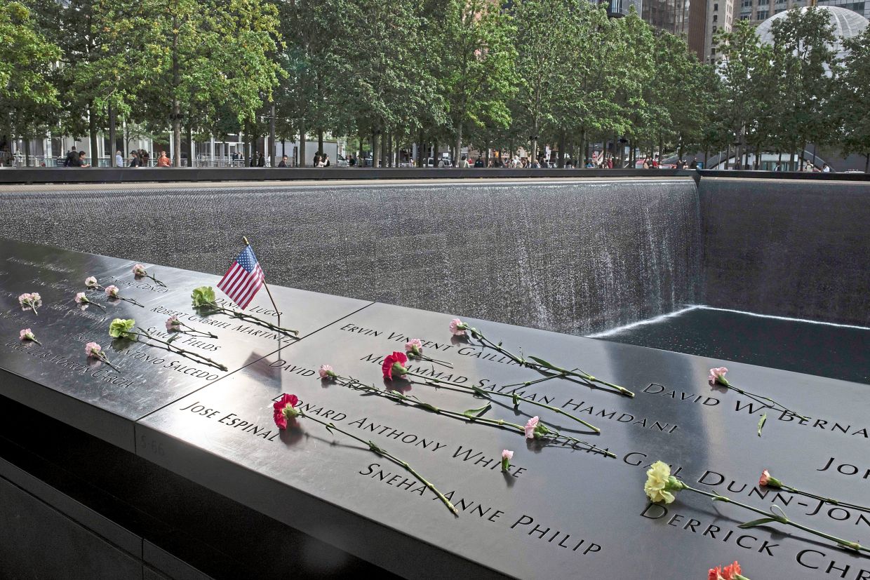 Flowers left at the 9/11 Memorial & Museum in Manhattan for the victims. — Dave Sanders/The New York Times