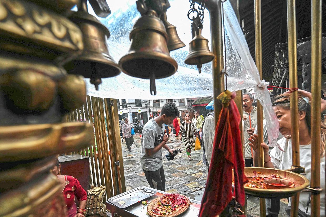 A new chapter: Hindu devotees offering prayers at a temple in the Durbar Square in Kathmandu.- AFP