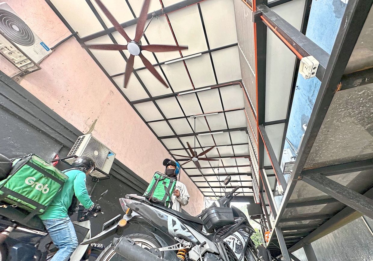 The Selayang hub for delivery riders, off Jalan 2/16 in Bandar Baru Selayang, is a shaded rest stop with fans and benches.