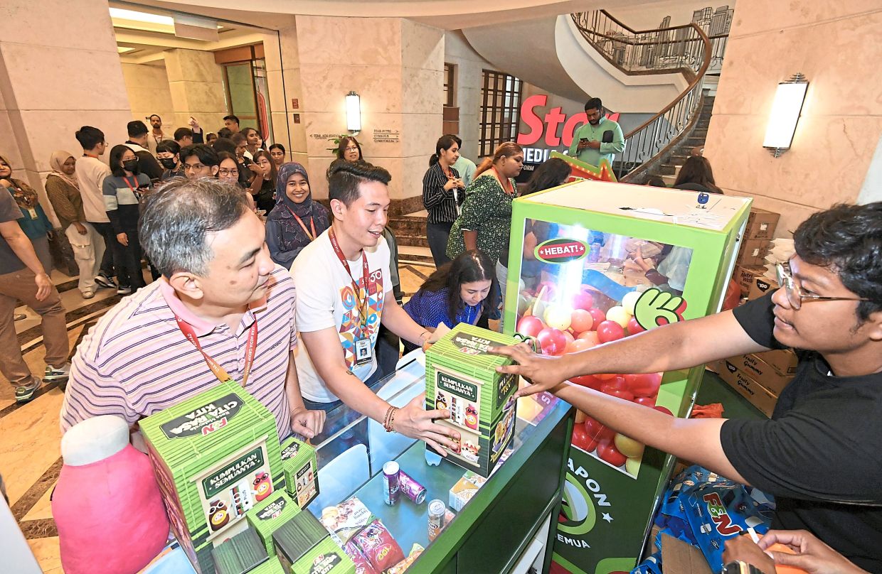 Staff members lining up to try their luck for limited-issue plushies from the ‘gashapon’ machine.