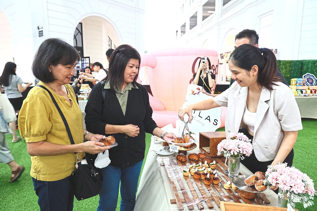 Chong (right) attending to visitors at her booth.
