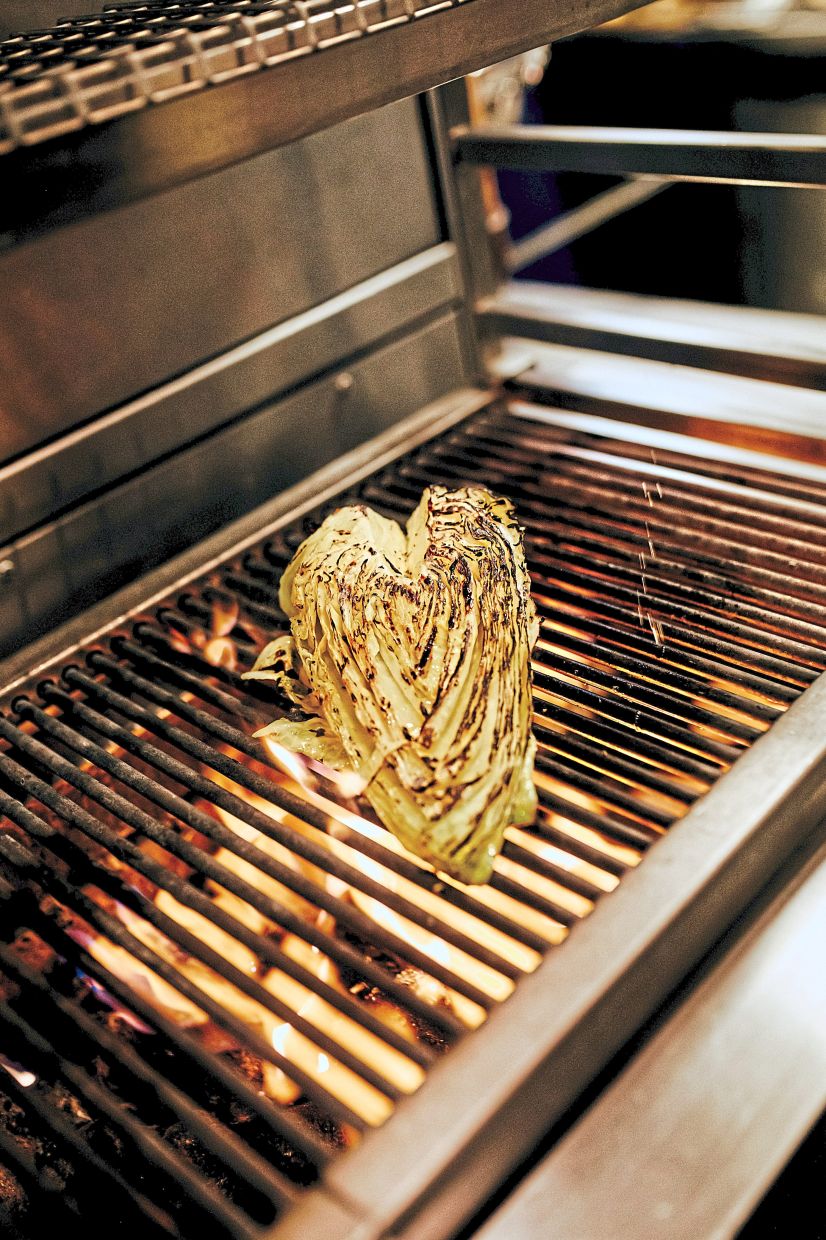 Hispi cabbage is grilled at a Hoppers restaurant in London. — Photos: PETER FLUDE/The New York Times