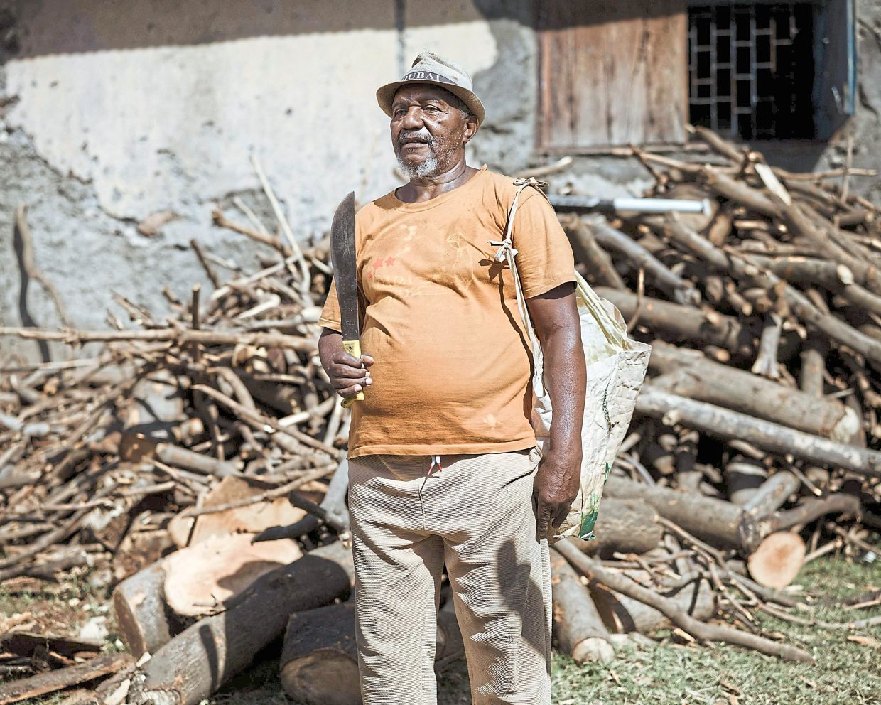 Alihadhur Said, a former policeman turned log trader, poses for a portrait at an ylang-ylang flower distillery in Bambao Mtsanga.