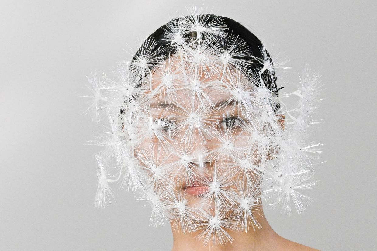 TOPSHOT - A model displays a creation from the Yes By Yesir collection by Ye Qian during the China Fashion Week in Beijing. -- Photo by WANG Zhao / AFP