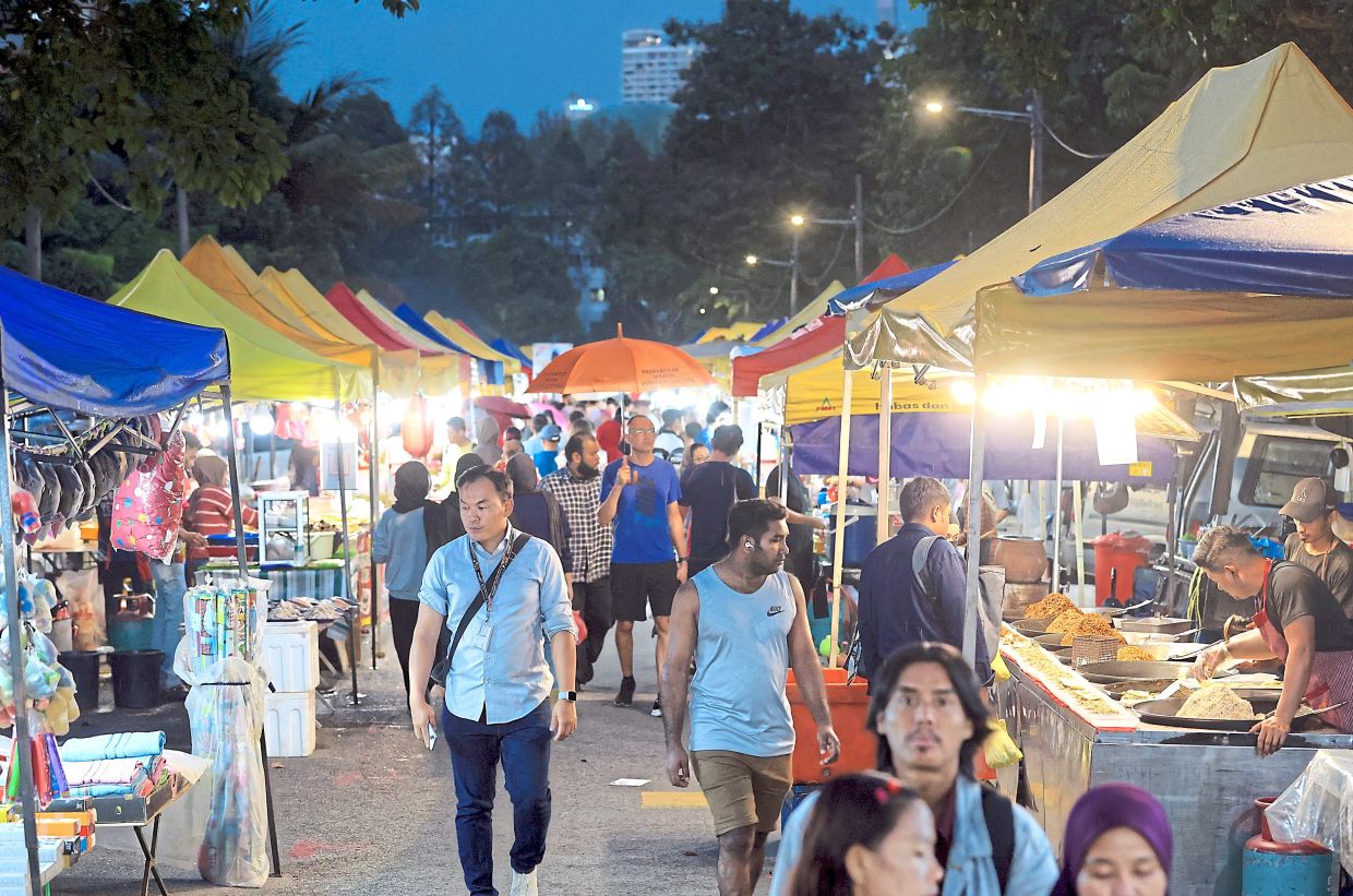 Crowds moving through the Section 17 night market, checking out the food and wares on sale.