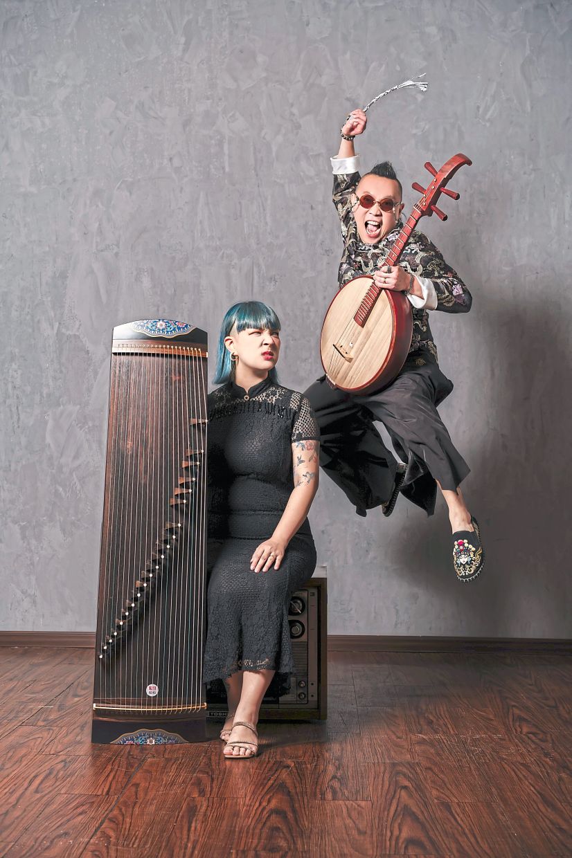 Lum (left) on gu zheng, and Tan on ukulele and ruan, cover popular songs with a unique twist. — LUM YI MANN 