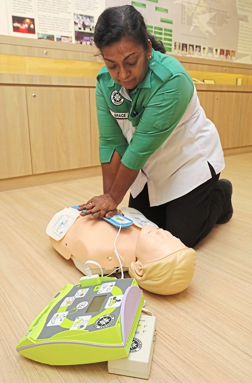 Lifesaver: St John Ambulance Malaysia’s Grace Uma Rani demonstrating how to use an AED and to carry out CPR on a mannequin in this file photo.