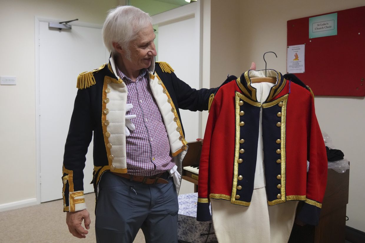 Chris Oswald, chair of the Hampshire Regency Dancers, displays a period costume he made during a practice in Winchester, England. Photo: AP