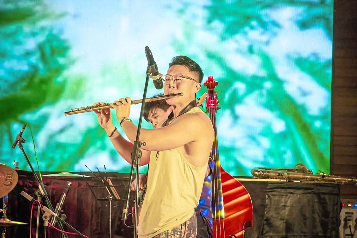 A musician captivates the audience with a flute solo at the Sepilok Jazz Festival.
