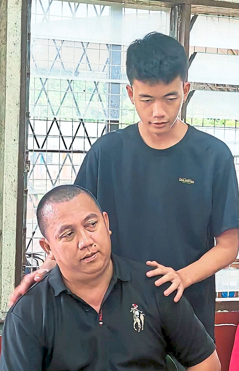 Devastating loss: The surviving family members Joseph (left) and his eldest son, Xavier.