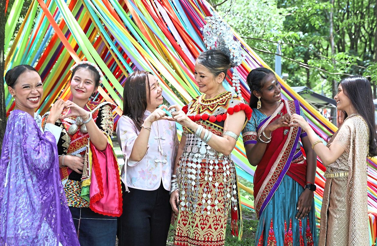 Picture perfect: (From left) Afrina Hanie, EvaLea, YiHui, Rosalind Kamis, N. Tana Letchumy and Kessara Suvanphet posing for pictures during the Malaysian Culture Festival 2025 at Taman Tasik Titiwangsa, Kuala Lumpur. — AZMAN GHANI/ The Star 