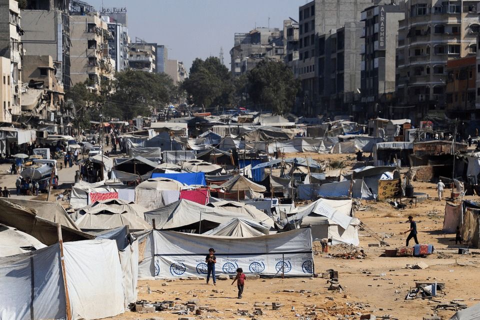 ‏Palestinians, displaced by the Israeli military offensive, take shelter in a tent camp on Sept 16.-- PHOTO: REUTERS
