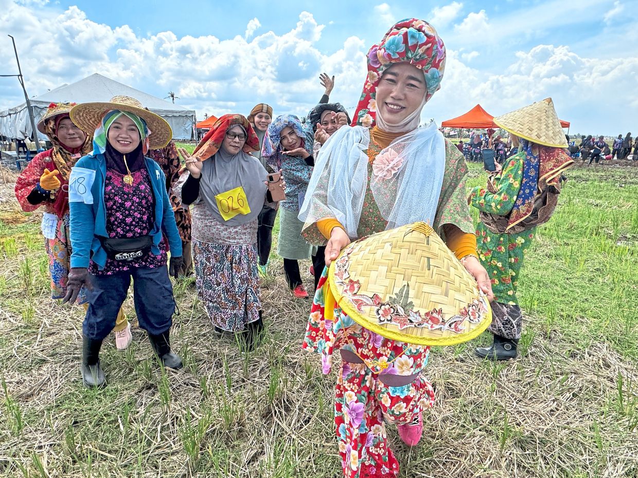 Rashida Ramli (front) dressed up in her best to vie for a place in the Queen of the Paddy Field contest.