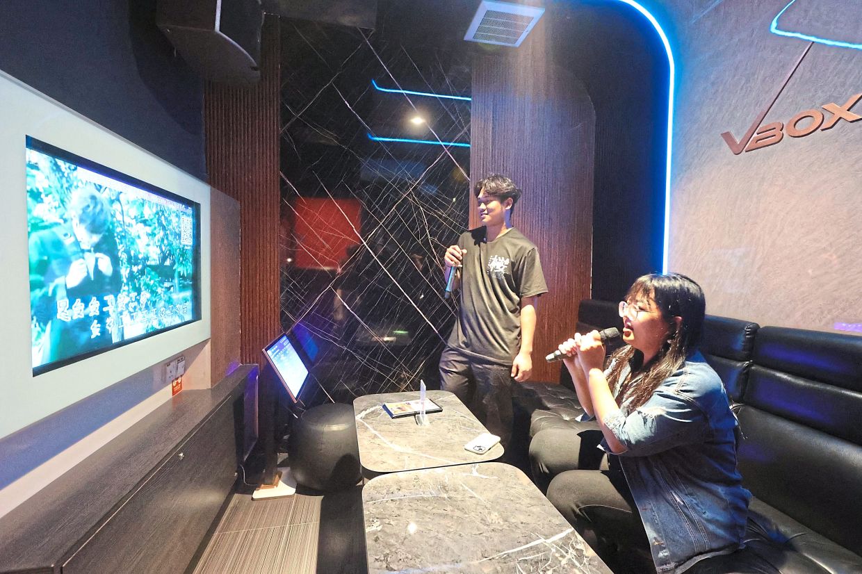 People enjoying a karaoke session in Taman Pelangi, at an outlet which charges only RM5 per person.